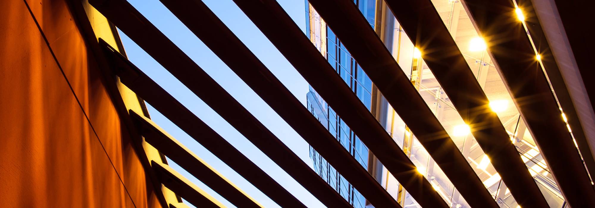 Wooden slated roof with bright sunshine breaking through the gaps