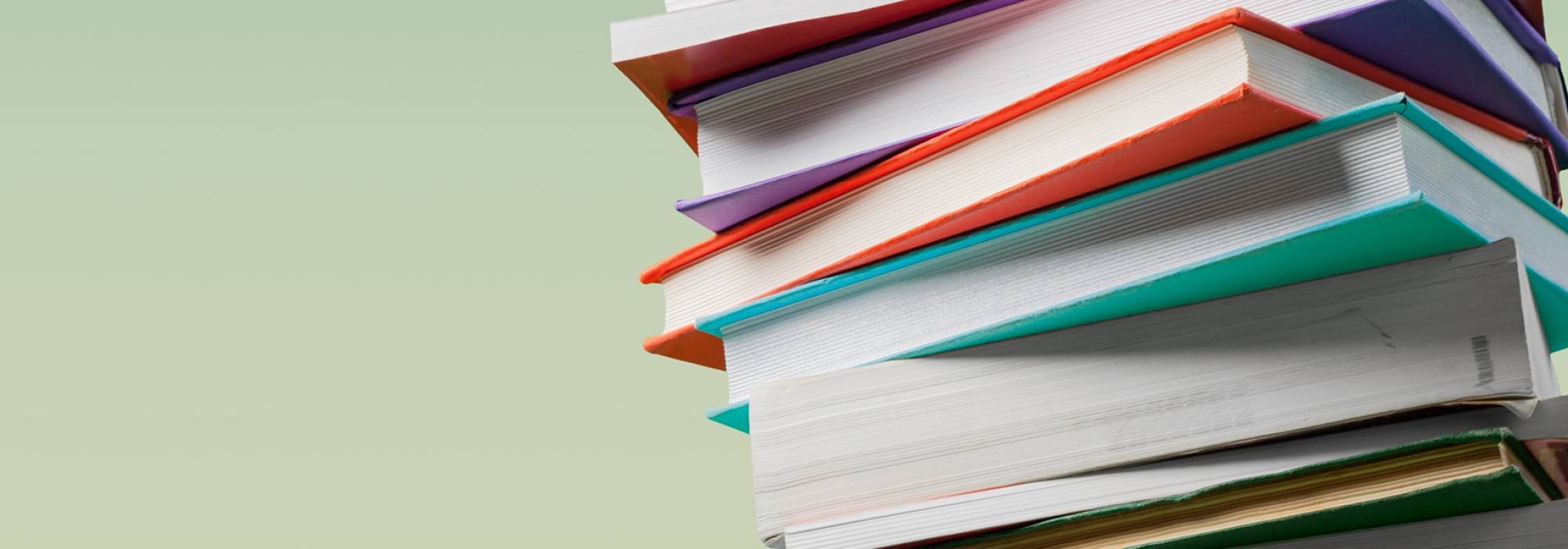 Stack of books on a light green background